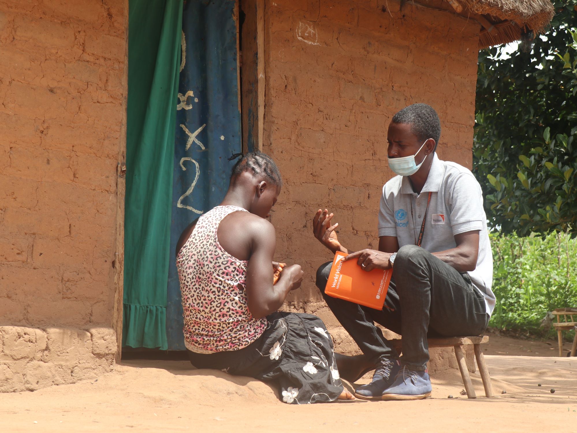 World Vision’s social worker Joseph Ndepi talks with former child soldier Grace 