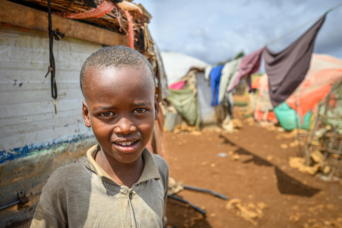 A young boy from Somalia stands among tents in an IDP settlement