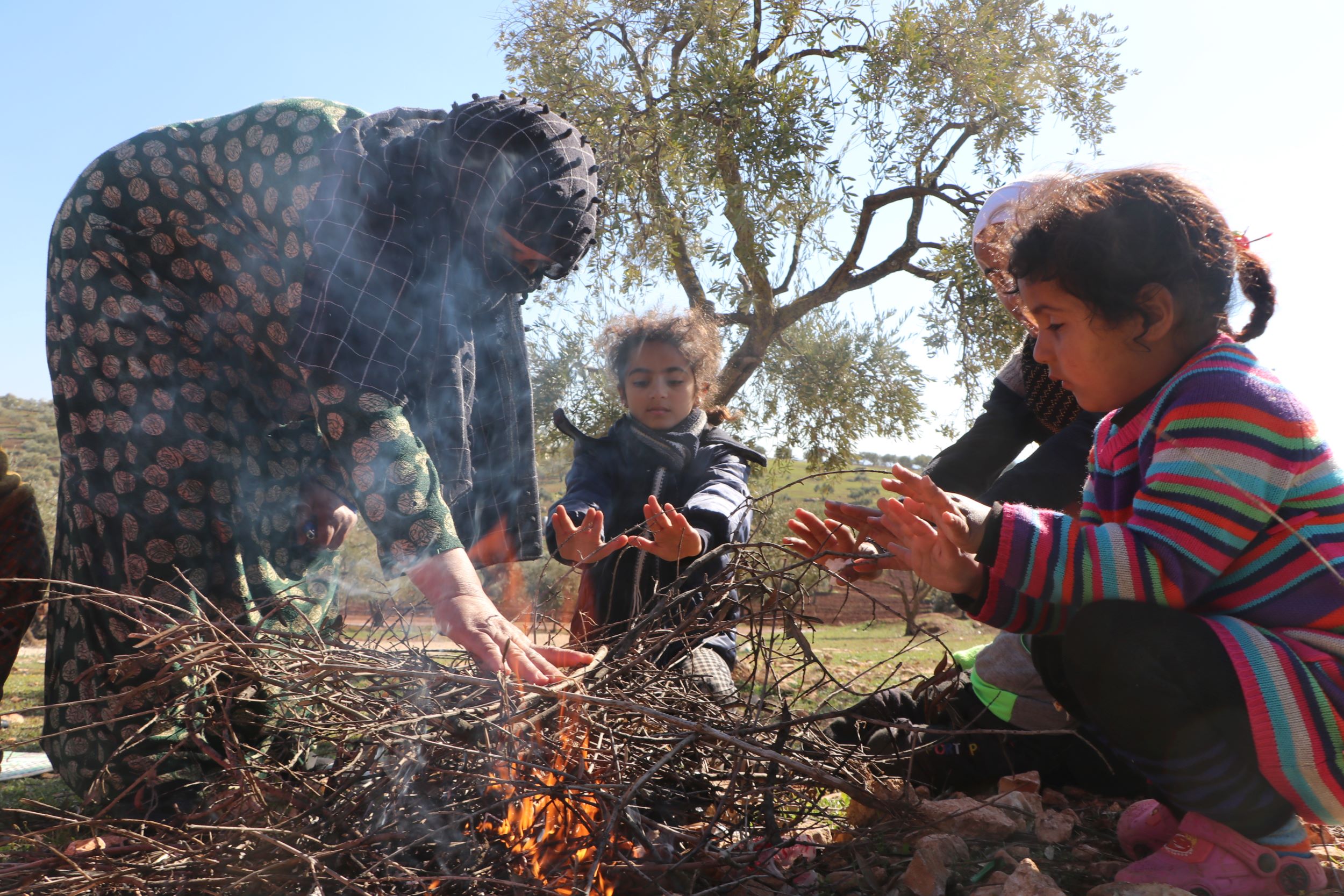Earthquake survivors keeping warm