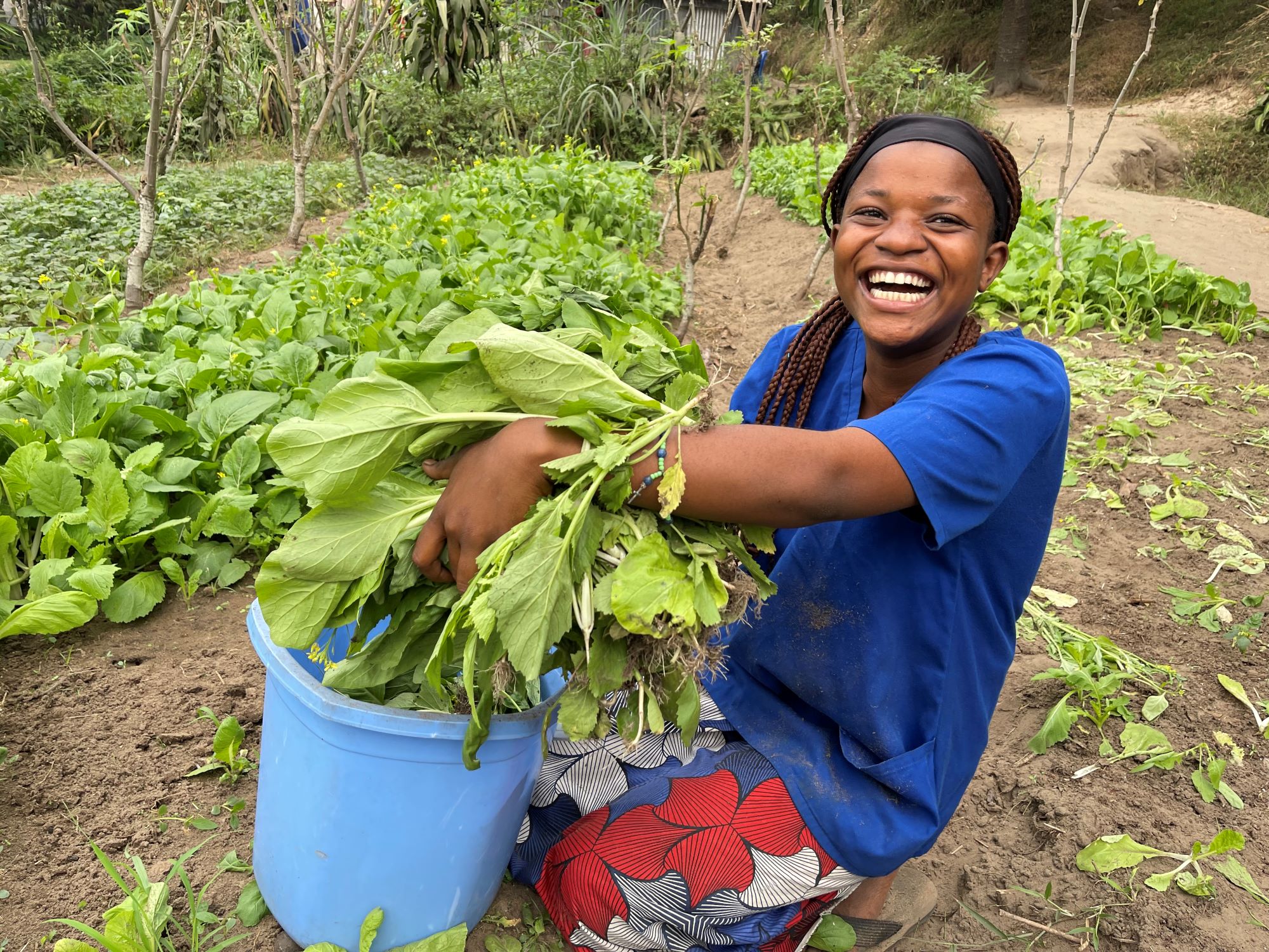 DRC teen girl smiling as she gardens