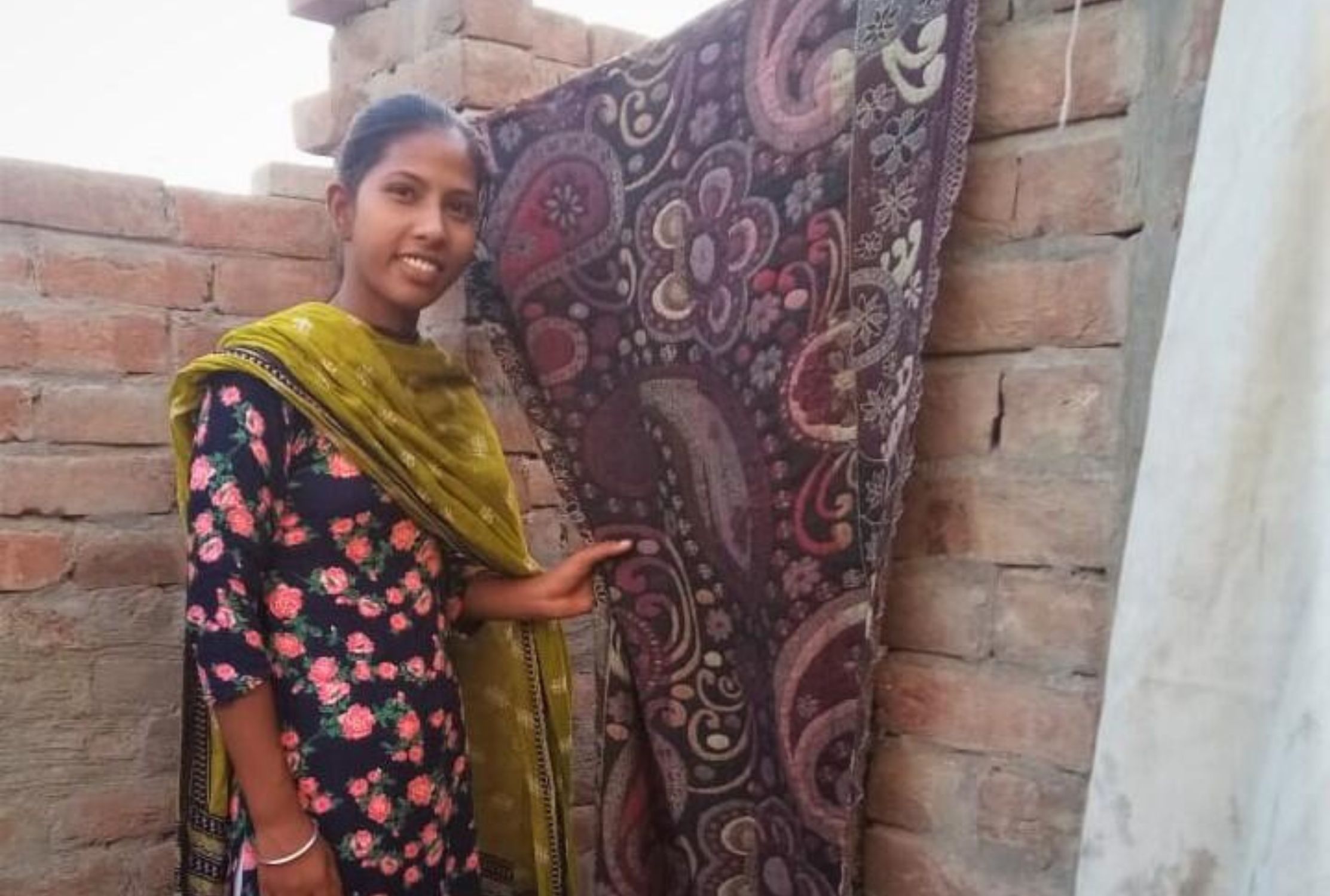 18-year-old Indian girl holding a large patterned cloth