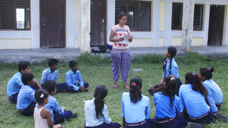 Saru speaks to a group of local schoolchildren about child rights and protection