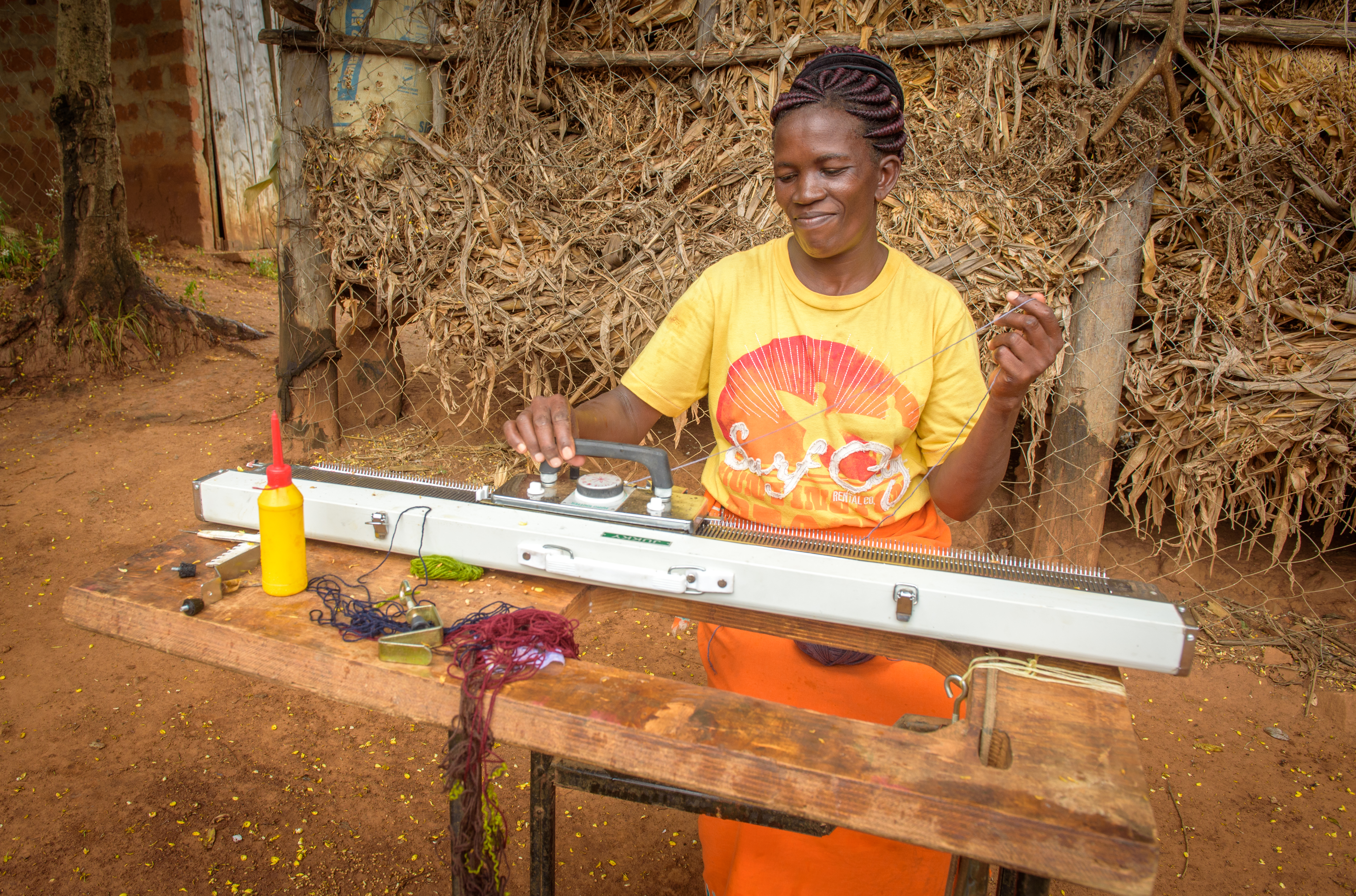 Janet weaves cloth at a loom, so she can earn  a livelihood for her family