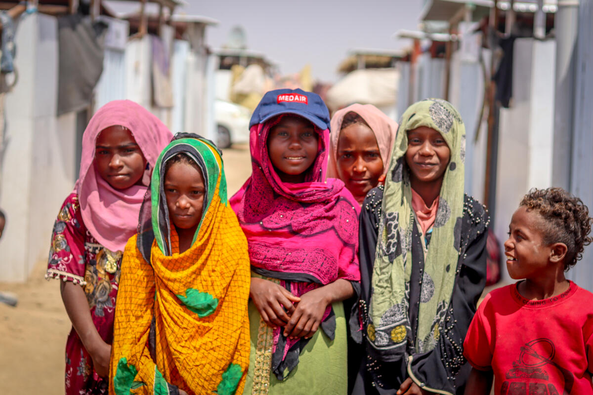 Yemeni refugee girl and her peers pose for a picture.