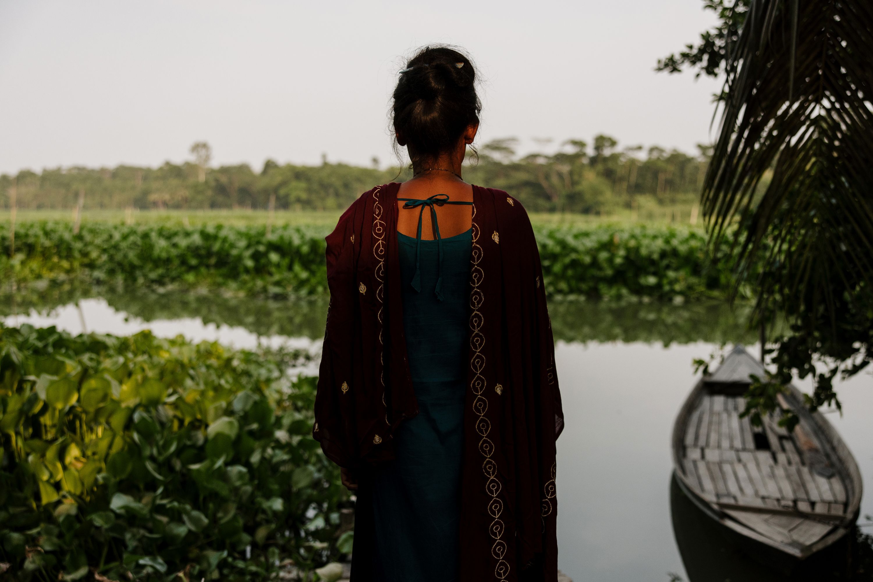 A young girl faces a field