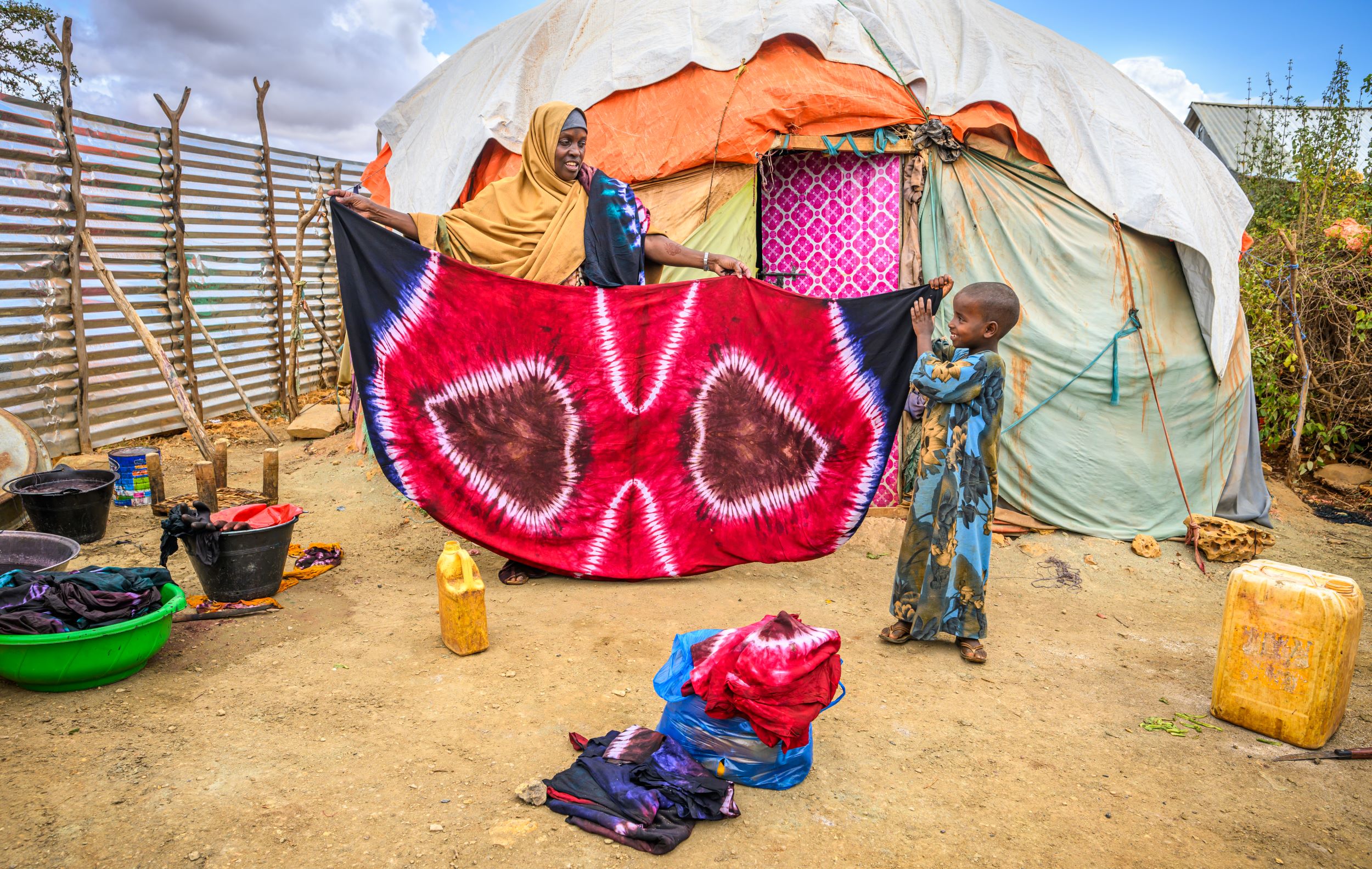 Somali woman and child displaying her tie-dye creation