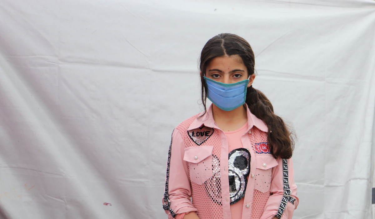 Young girl wearing face mask. 