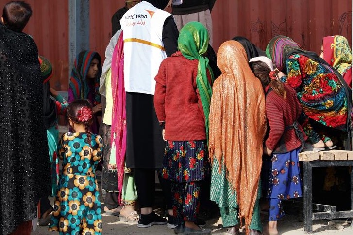A group of people collecting food supplies.
