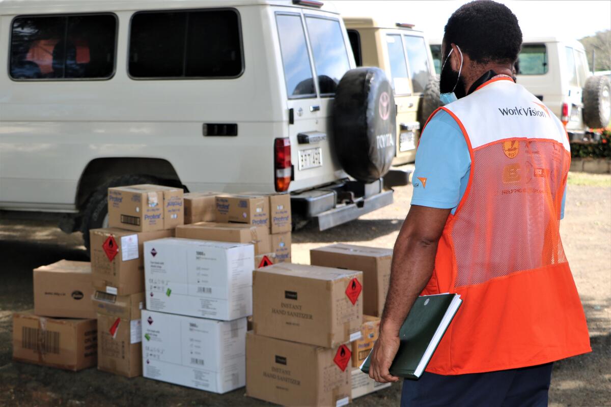 World Vision staff from Papua New Guinea with the relief kits to be distributed to those in need