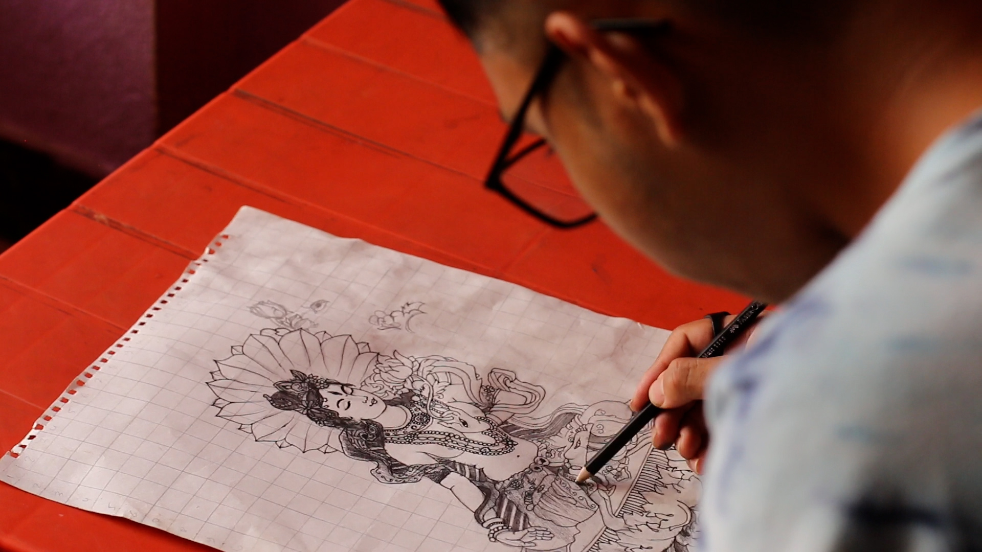 A Nepali boy drawing