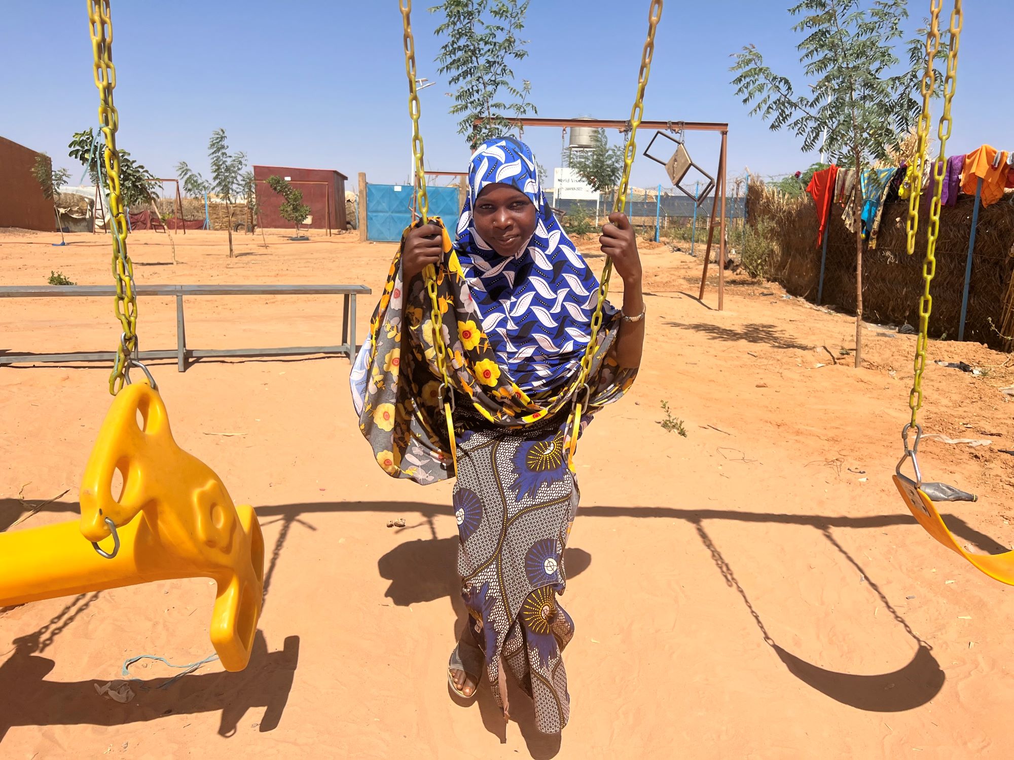 Displaced Niger girl on swing