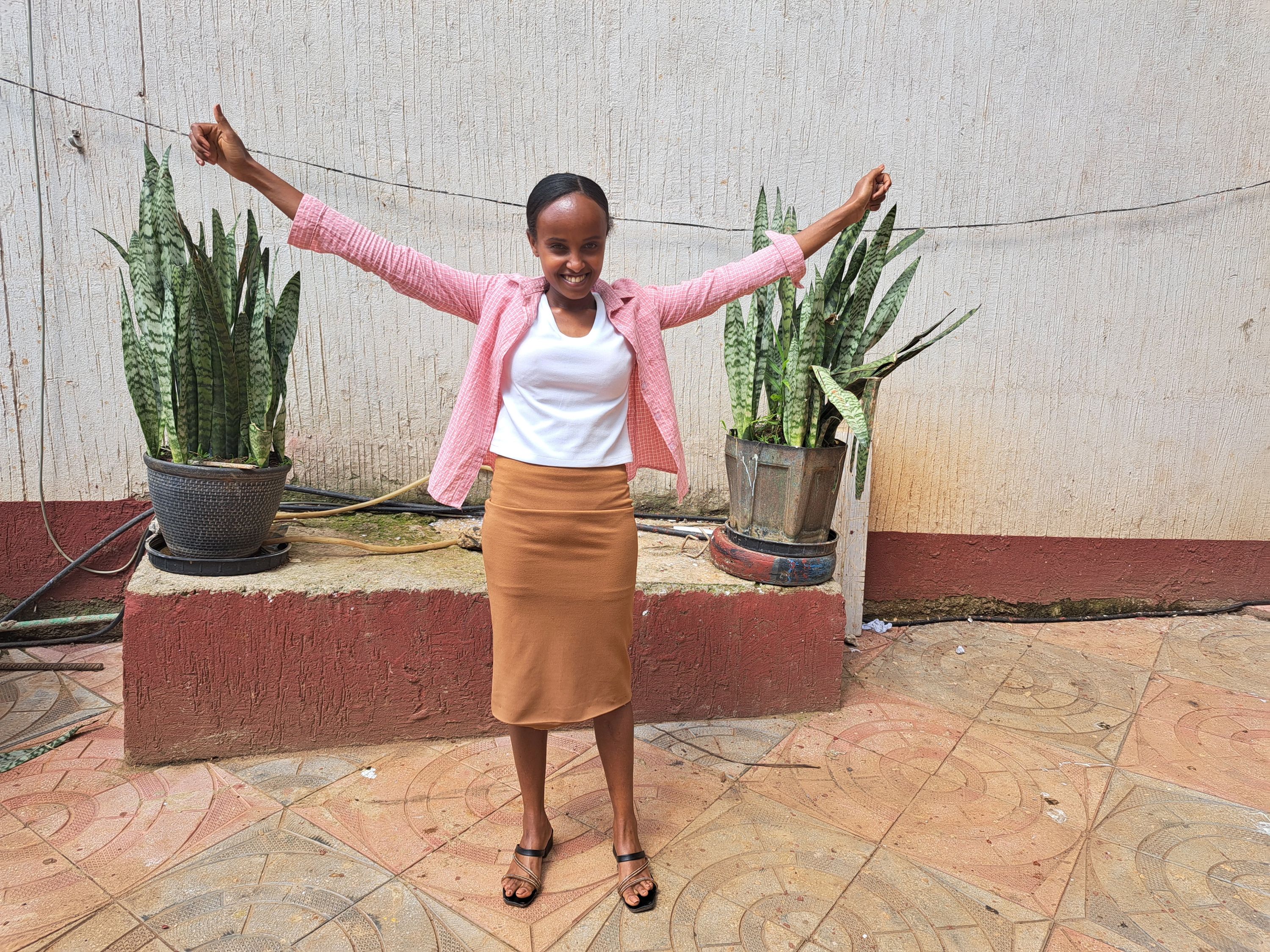 With her arms out wide, Martha embraces the future she now has and the future she can build for her younger sisters