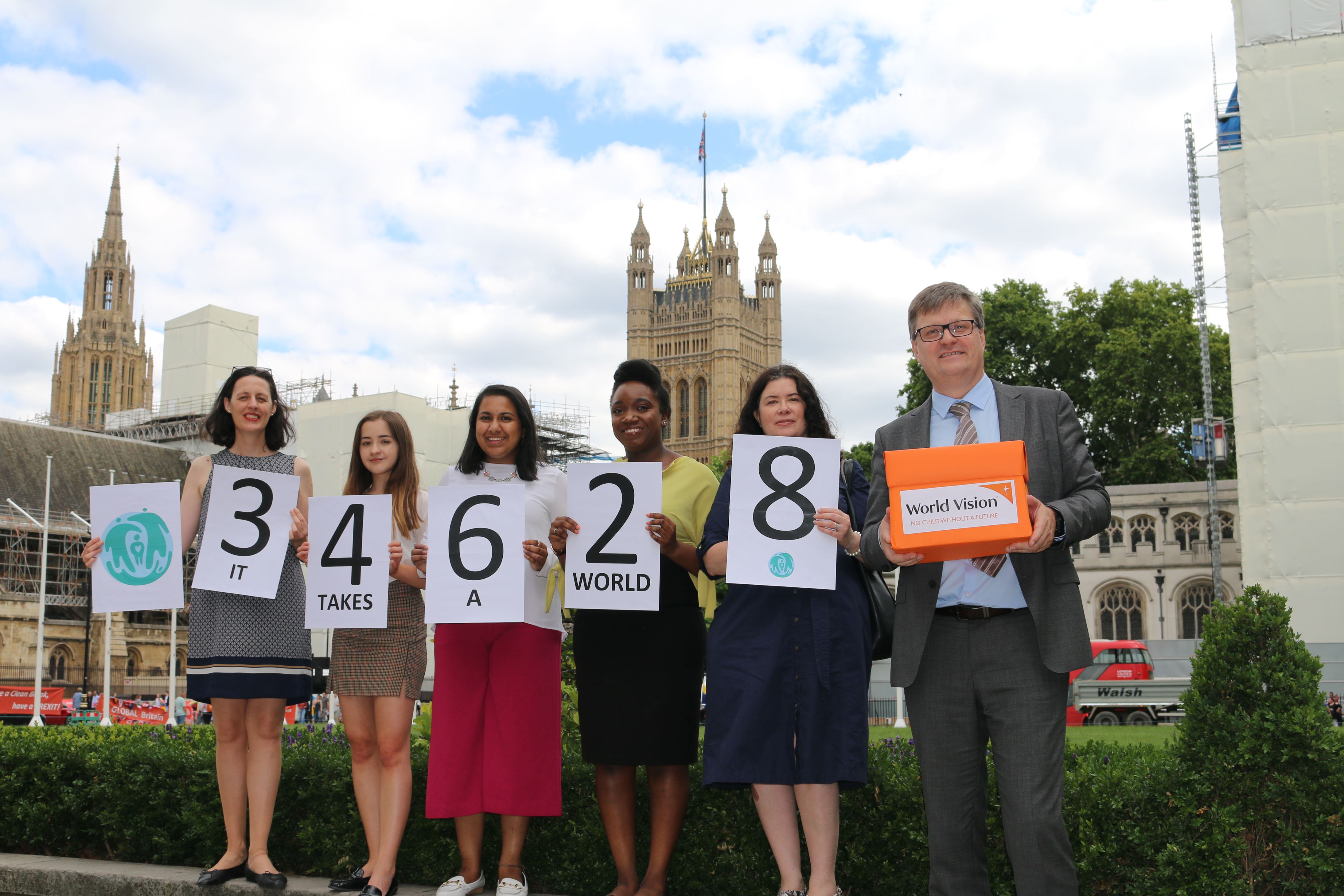 World Vision Youth Advocates and staff with the petition and total number of signatories, outside the Houses of Parliament