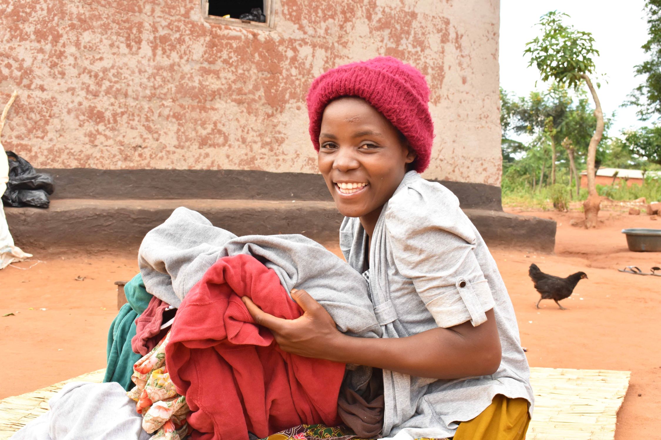 Young woman in Malawi holding clothes