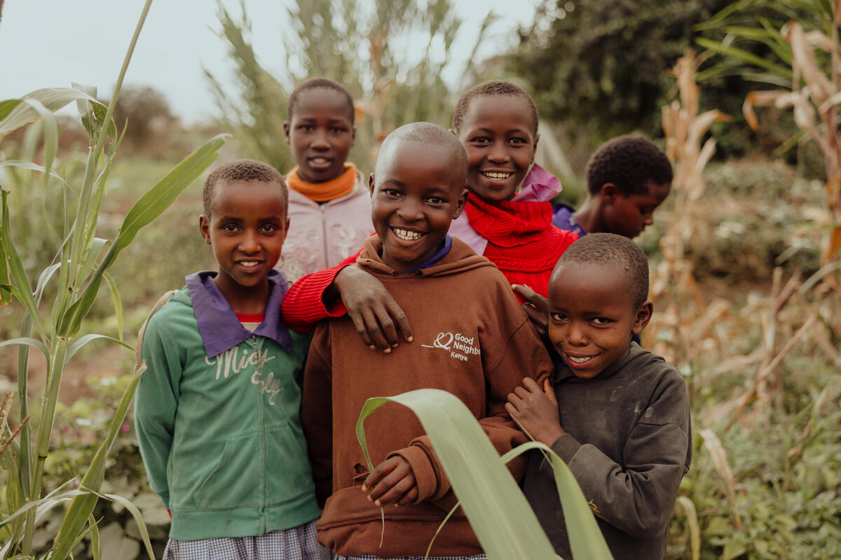 Five boys in a sponsored community in Kenya smile to the camera