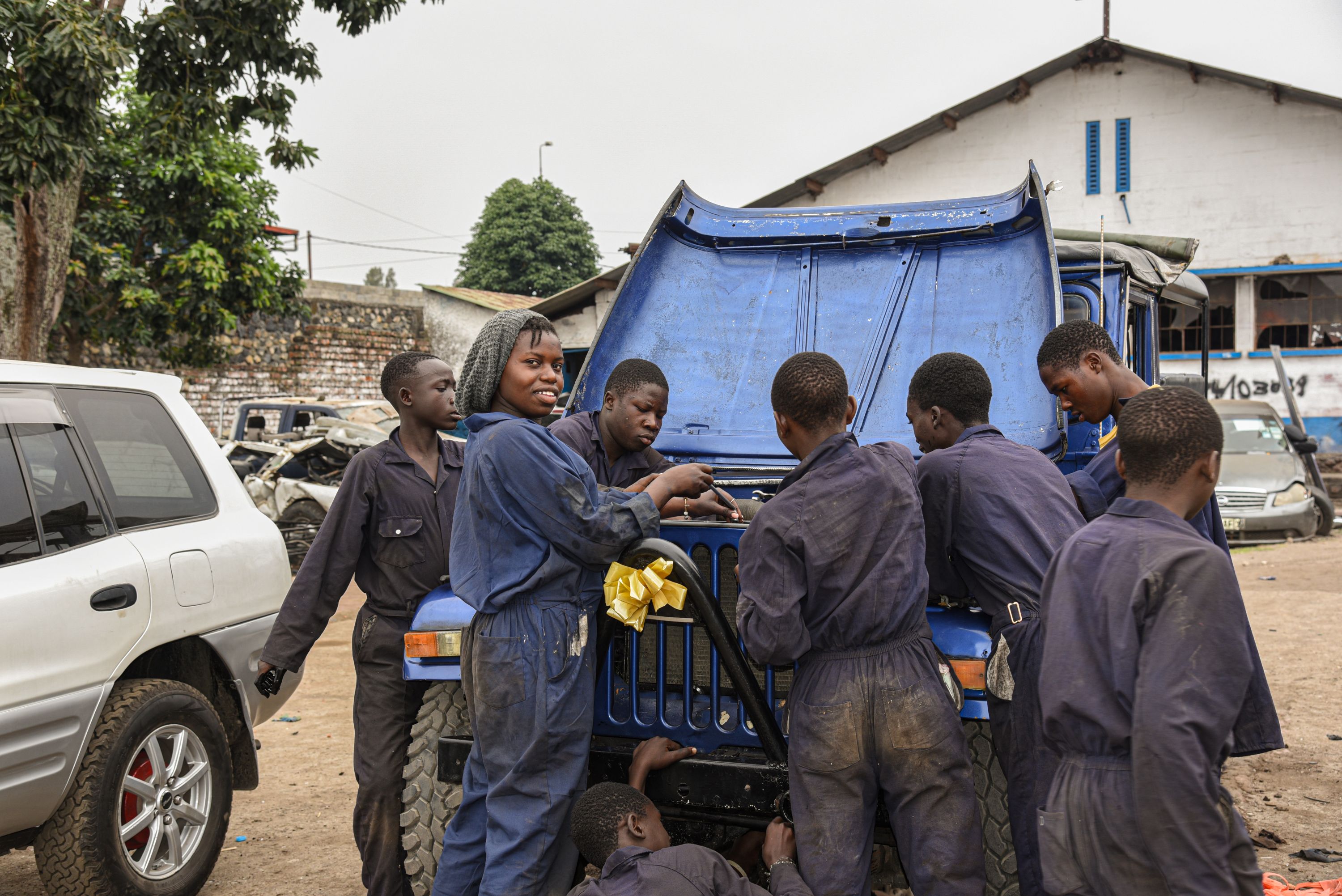 18-year-old Immaculée, posing with fellow students, has completed mechanics training through a World Vision programme