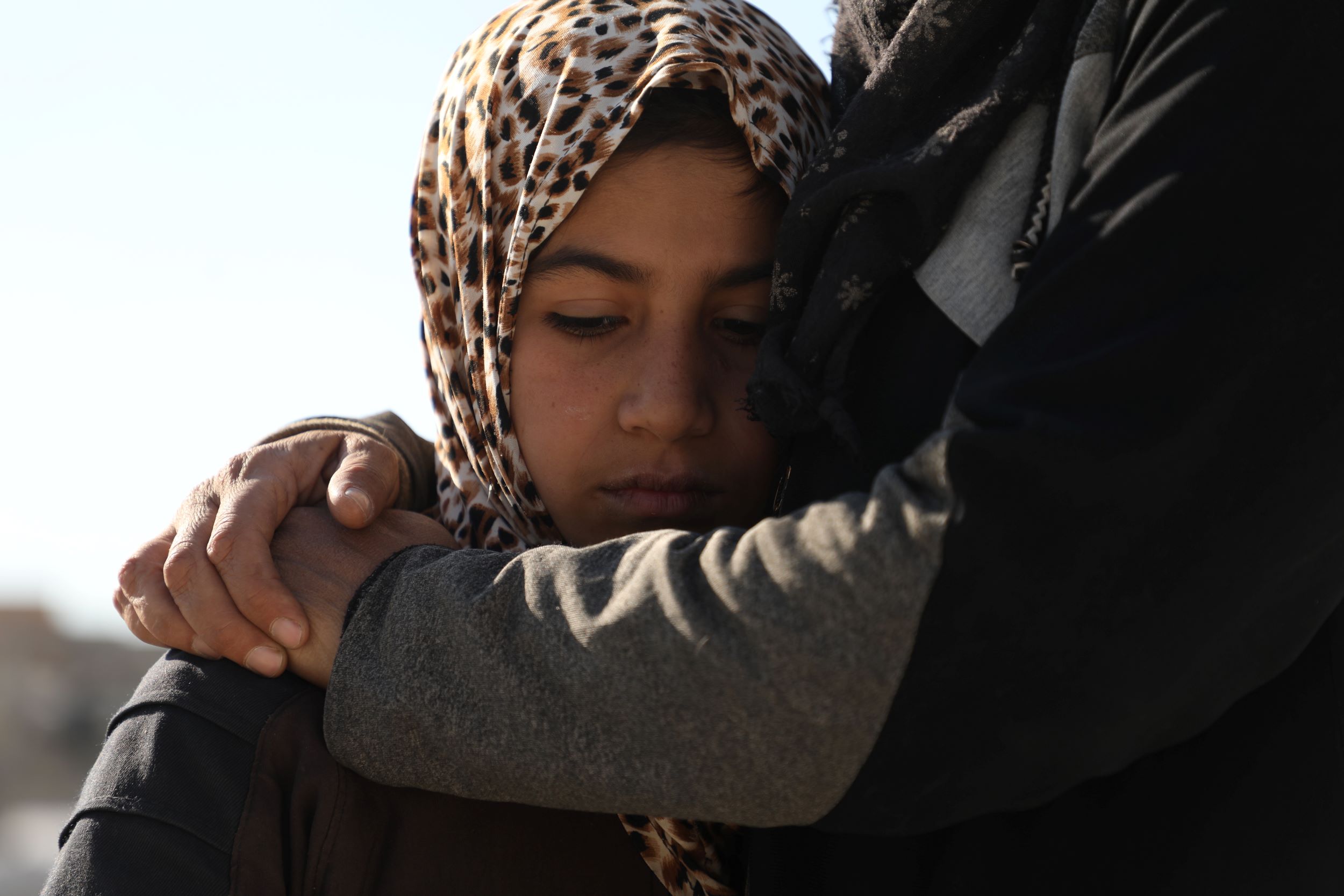 Syrian girl being comforted after the earthquakes