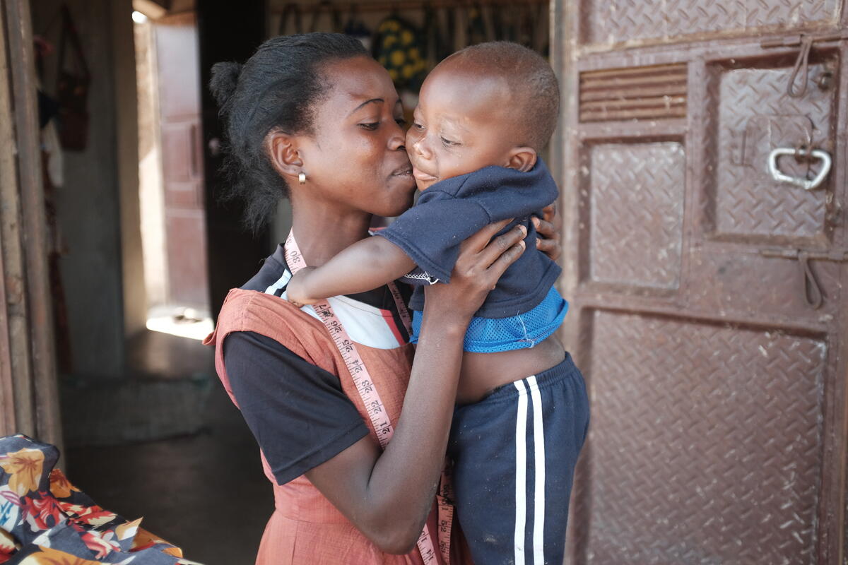 Young mother holding son