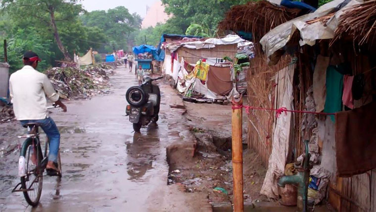 On-street shacks are flooded by monsoon rains