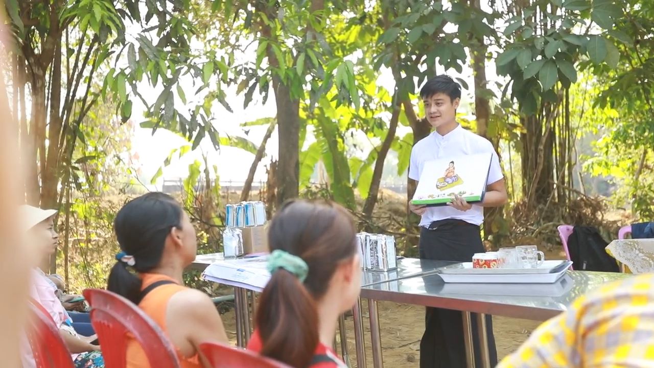 World Vision staff member giving community training about nutrition