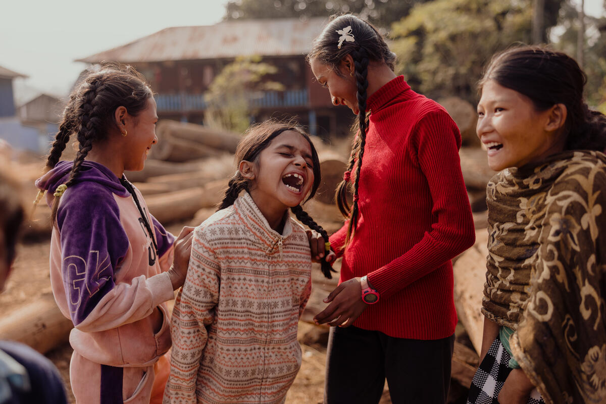 Four children in Nepal laughing together