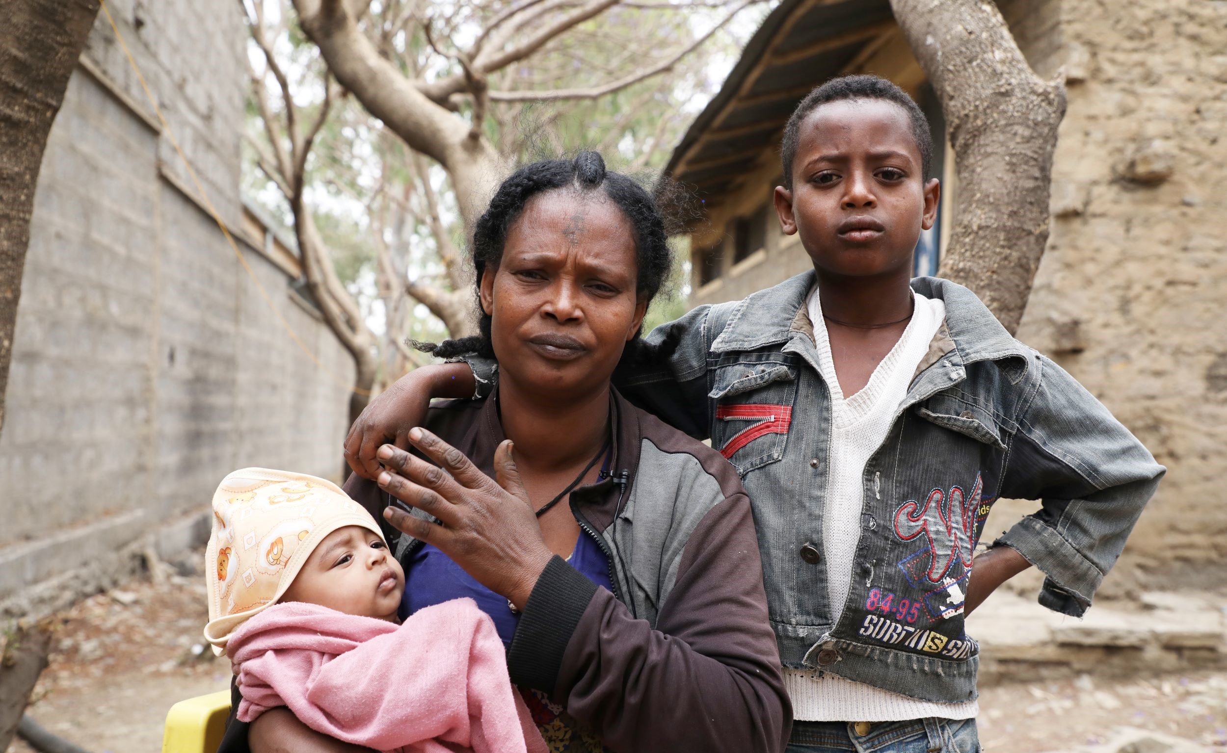 Young Ethiopian boy with his mum and baby sister