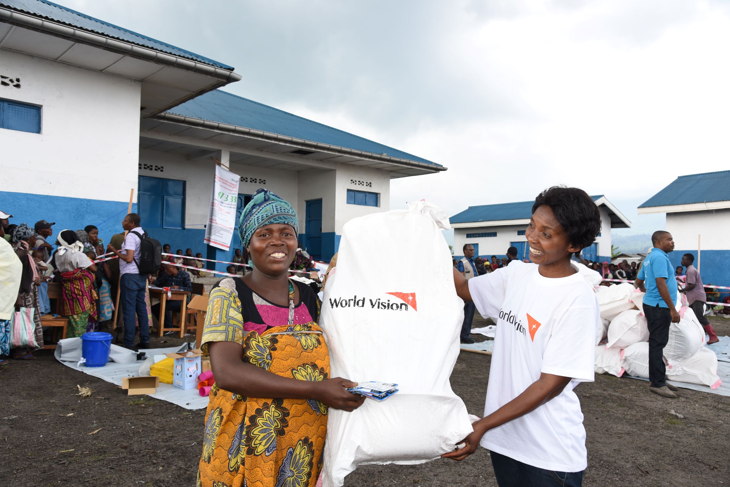 A Congolese woman collecting her WASH kit, enabling her to keep her children safe from waterborne diseases