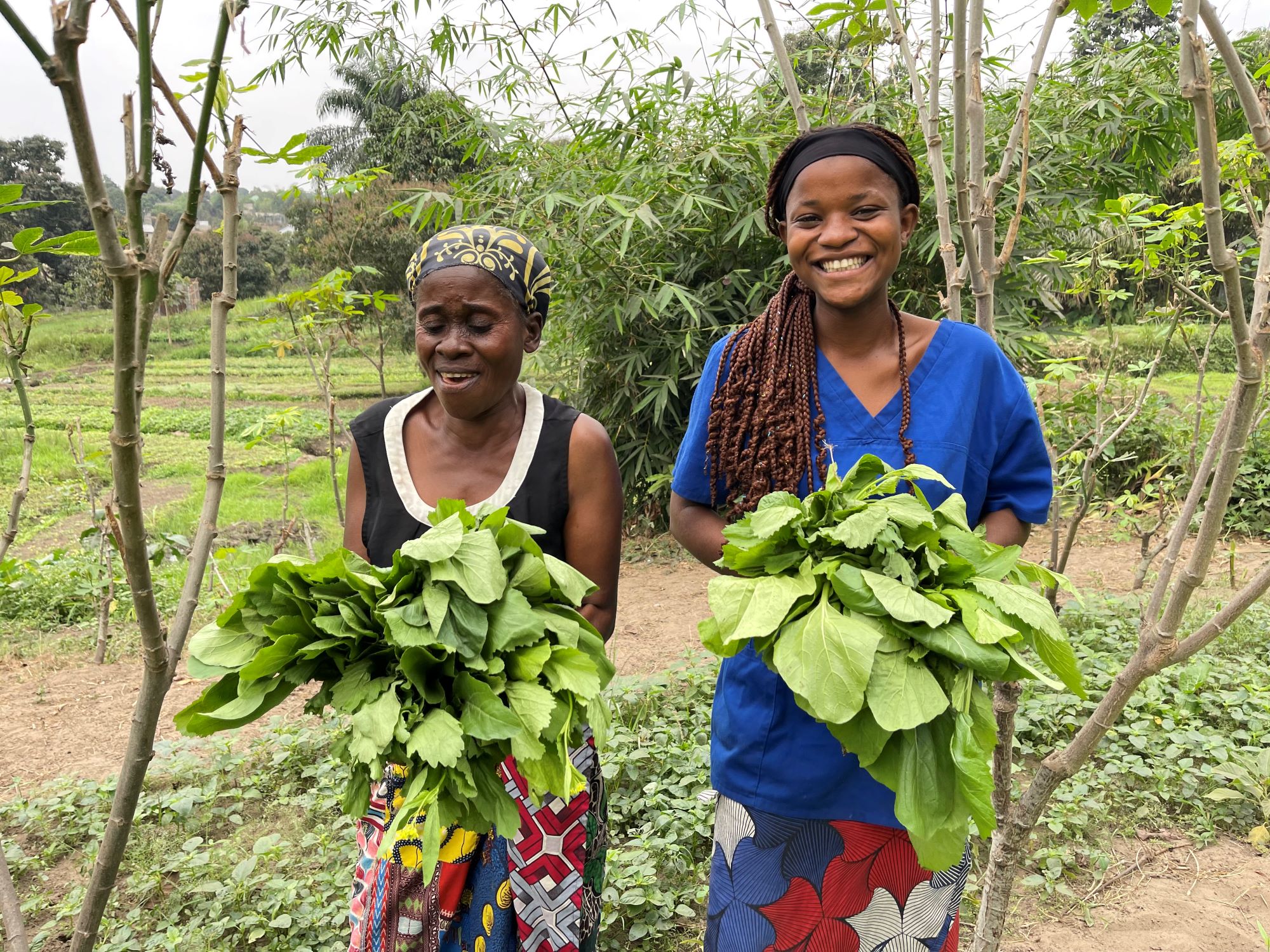 DRC teen and grandmother smiling in their garden