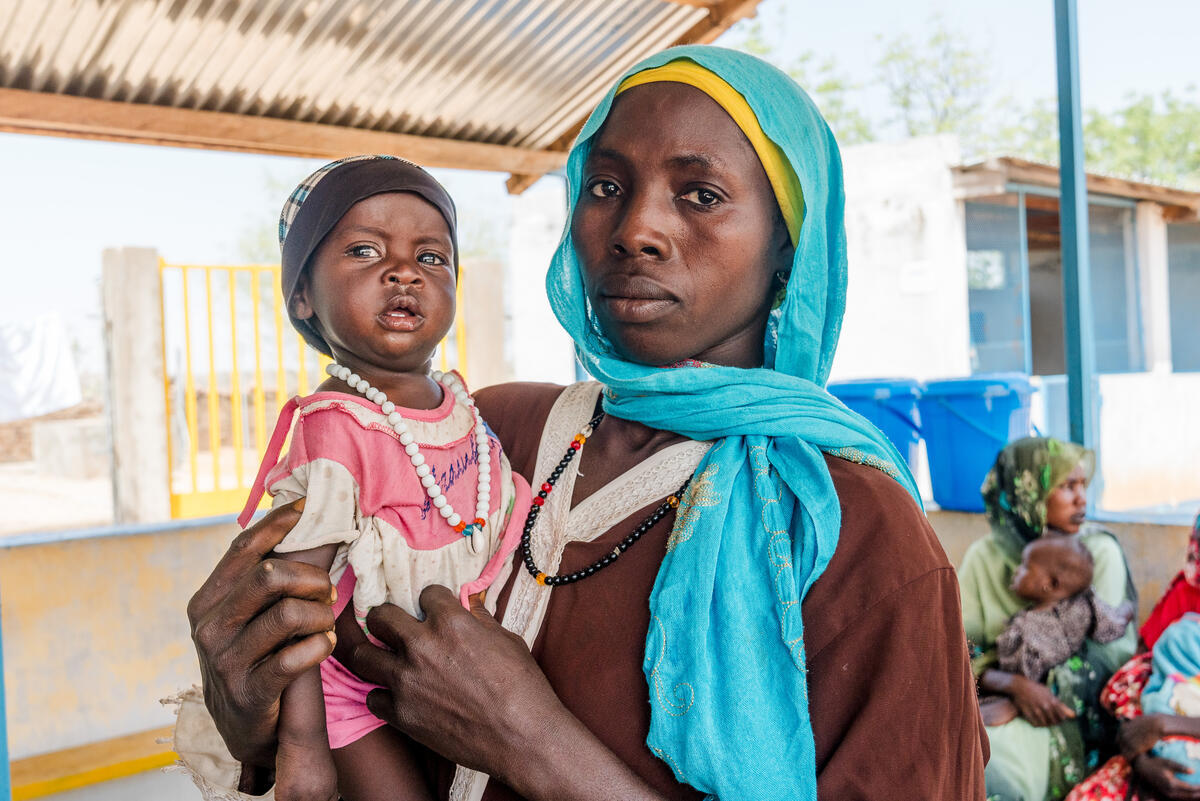 A mother brings her 13 month old child to a nutrition clinic for severe acute malnutrition in eastern Chad.