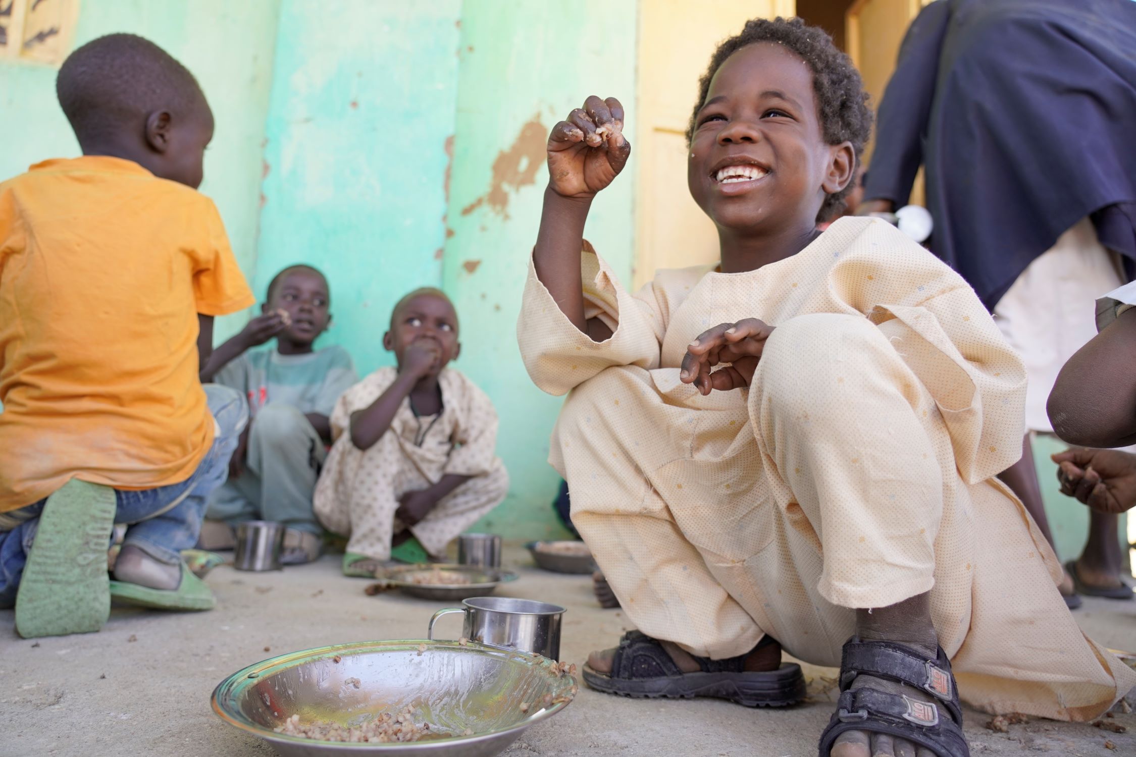 Young child enjoys food through World Vision Sudan project
