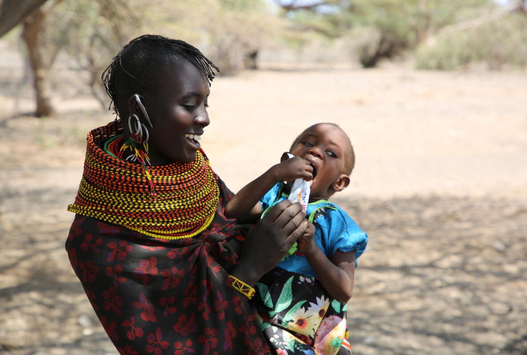 Kenyan mother feeding her baby