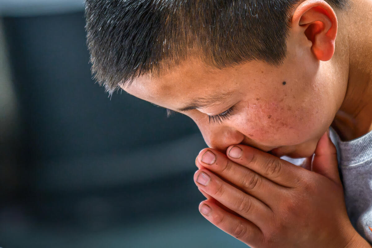 A young boy praying in Guatemala