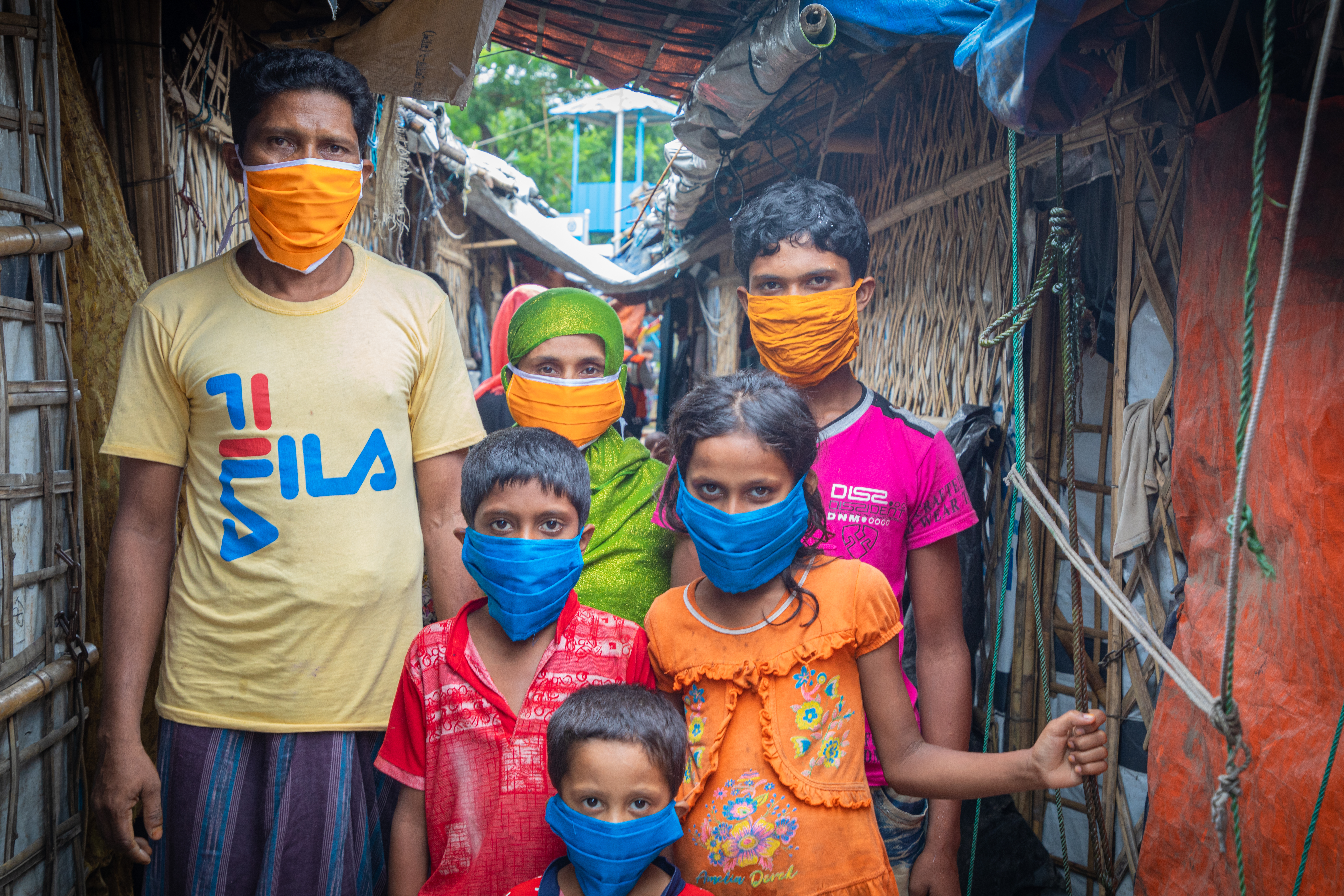 A family of two adults and four children in the refugee camp wearing facemasks, protecting them against the spread of COVID-19.