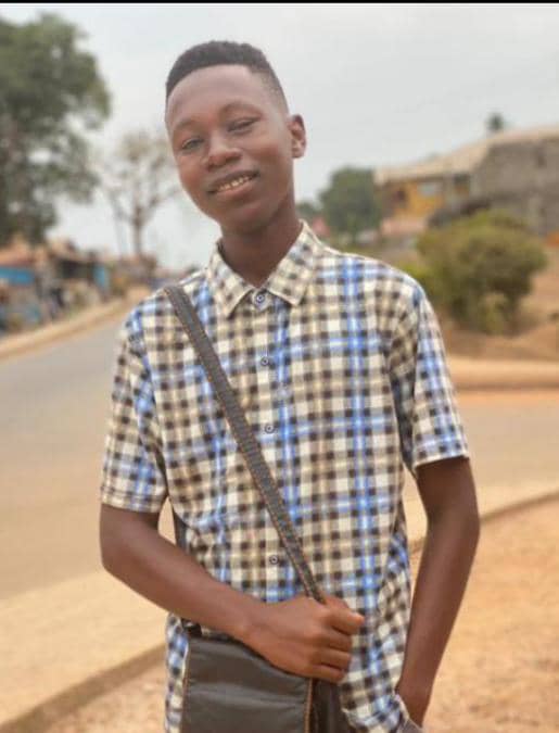 Teenage boy stands by the road in Sierra Leone