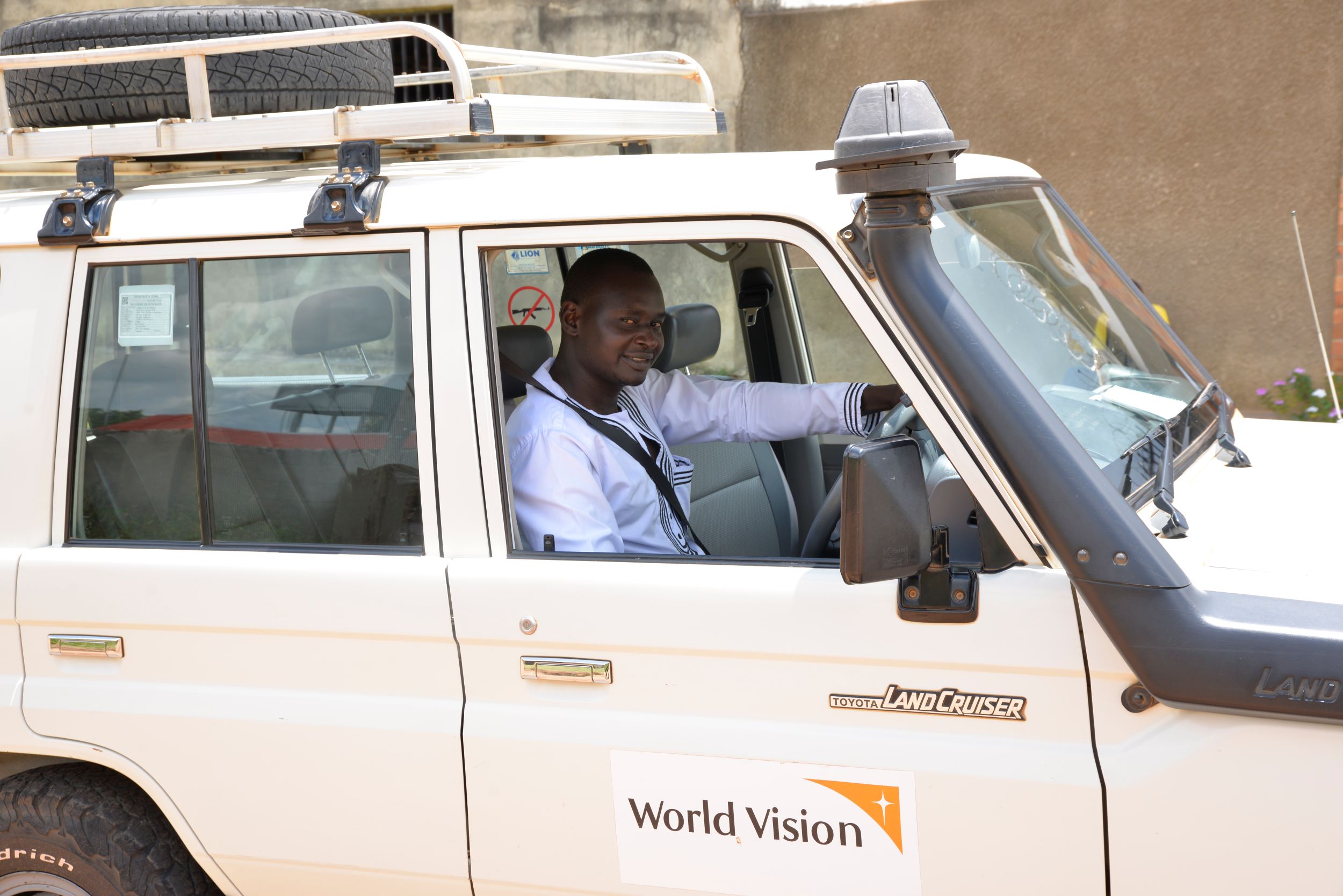 World Vision staff member in his car, Uganda