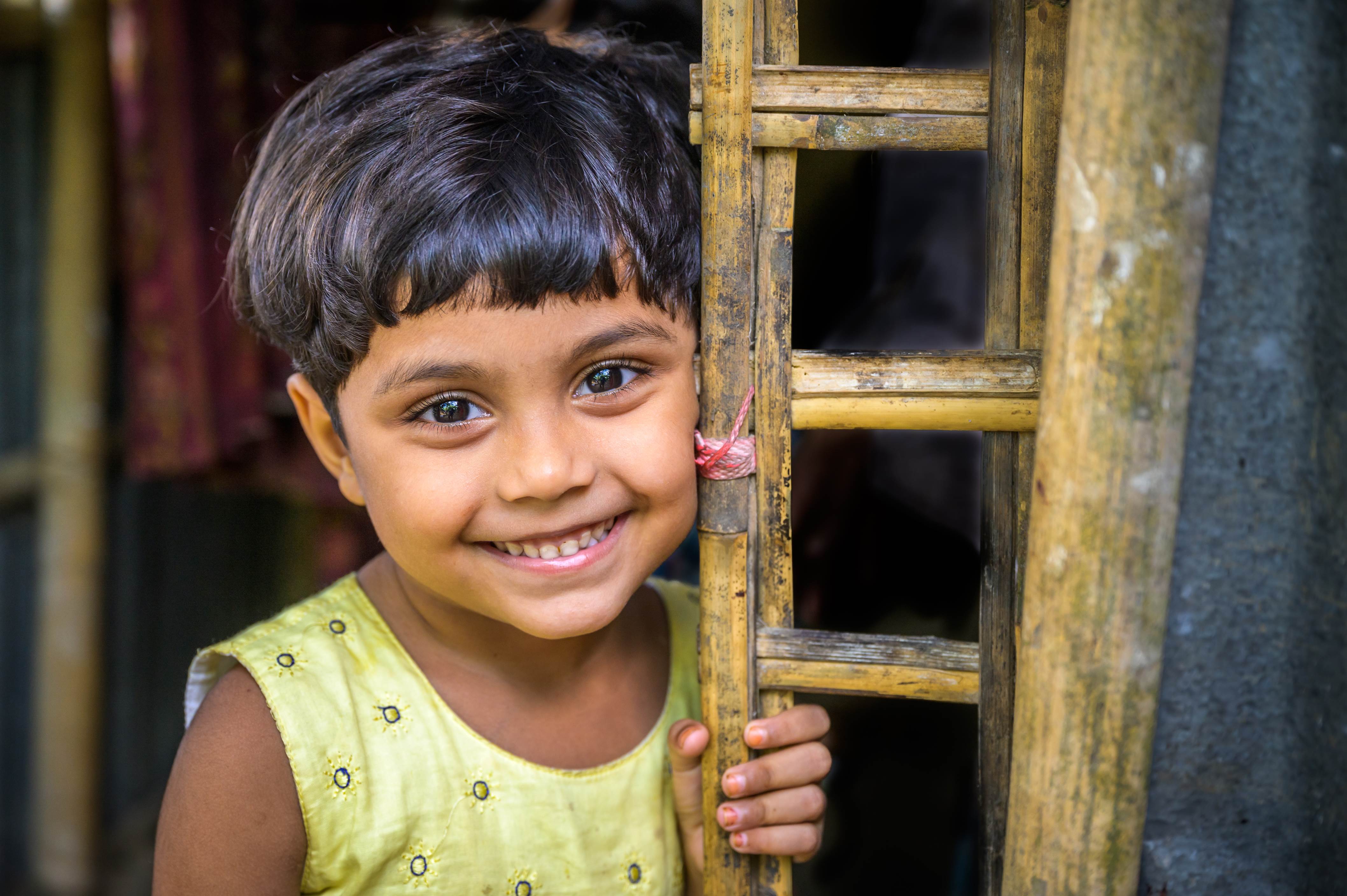 4-year-old Marua stands in door way