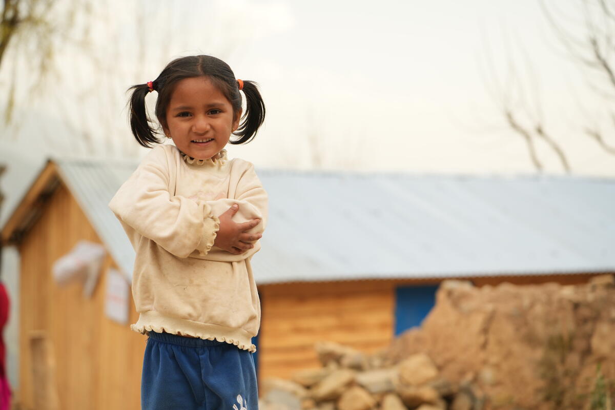 Nepalese girl stands outside temporary learning centre, constructed after the 2023 earthquake