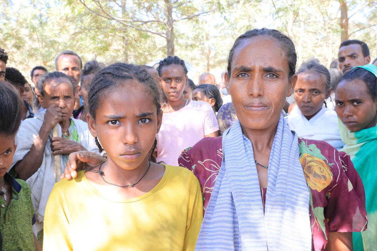 Woman affected by the Tigray crisis standing with her daughter