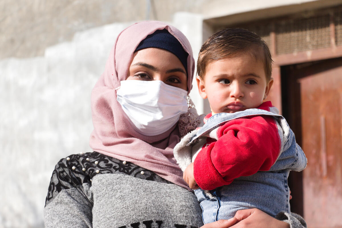 Fatimah, 18, holds her baby son