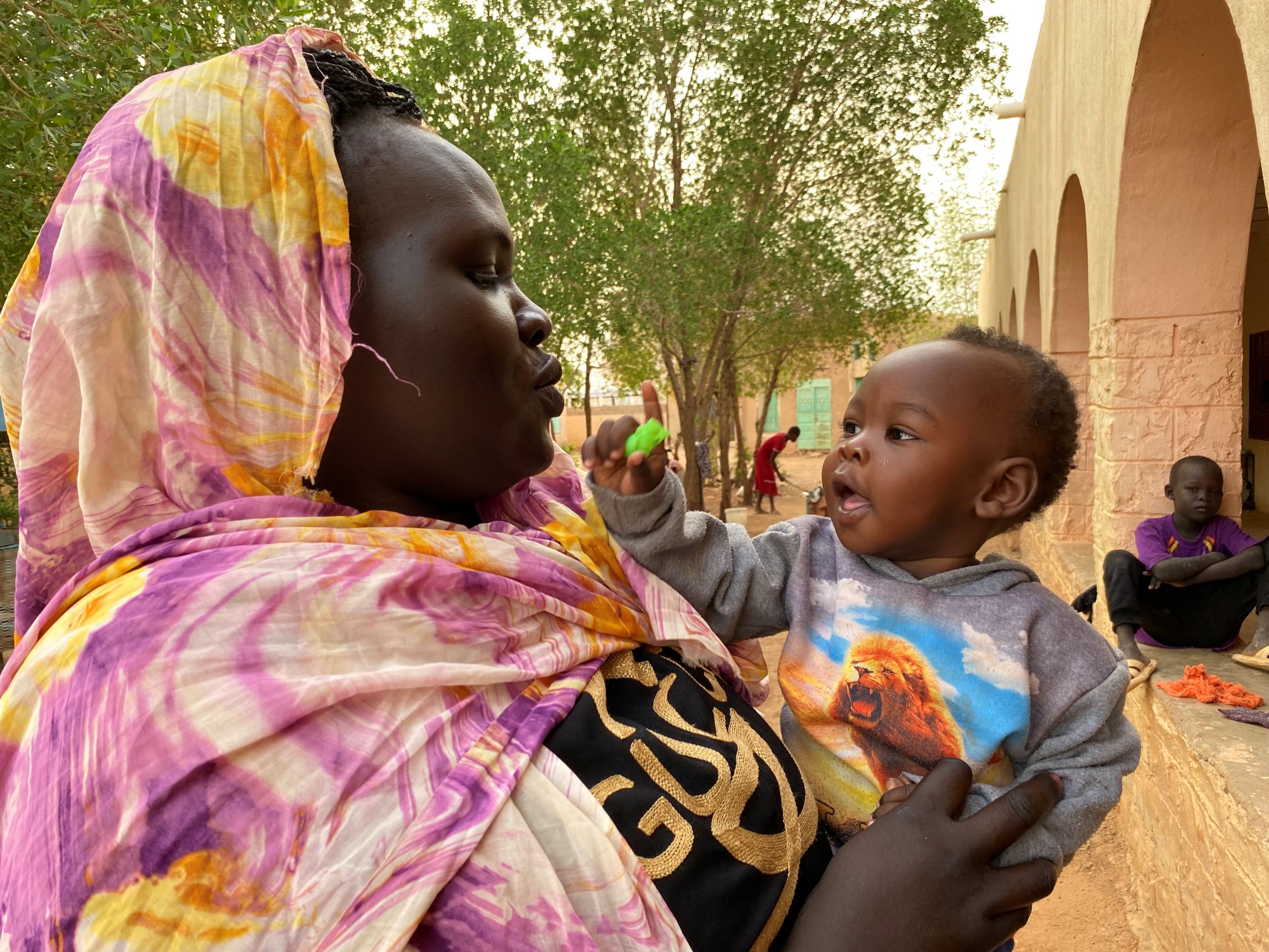 Sudanese mother with child in arms