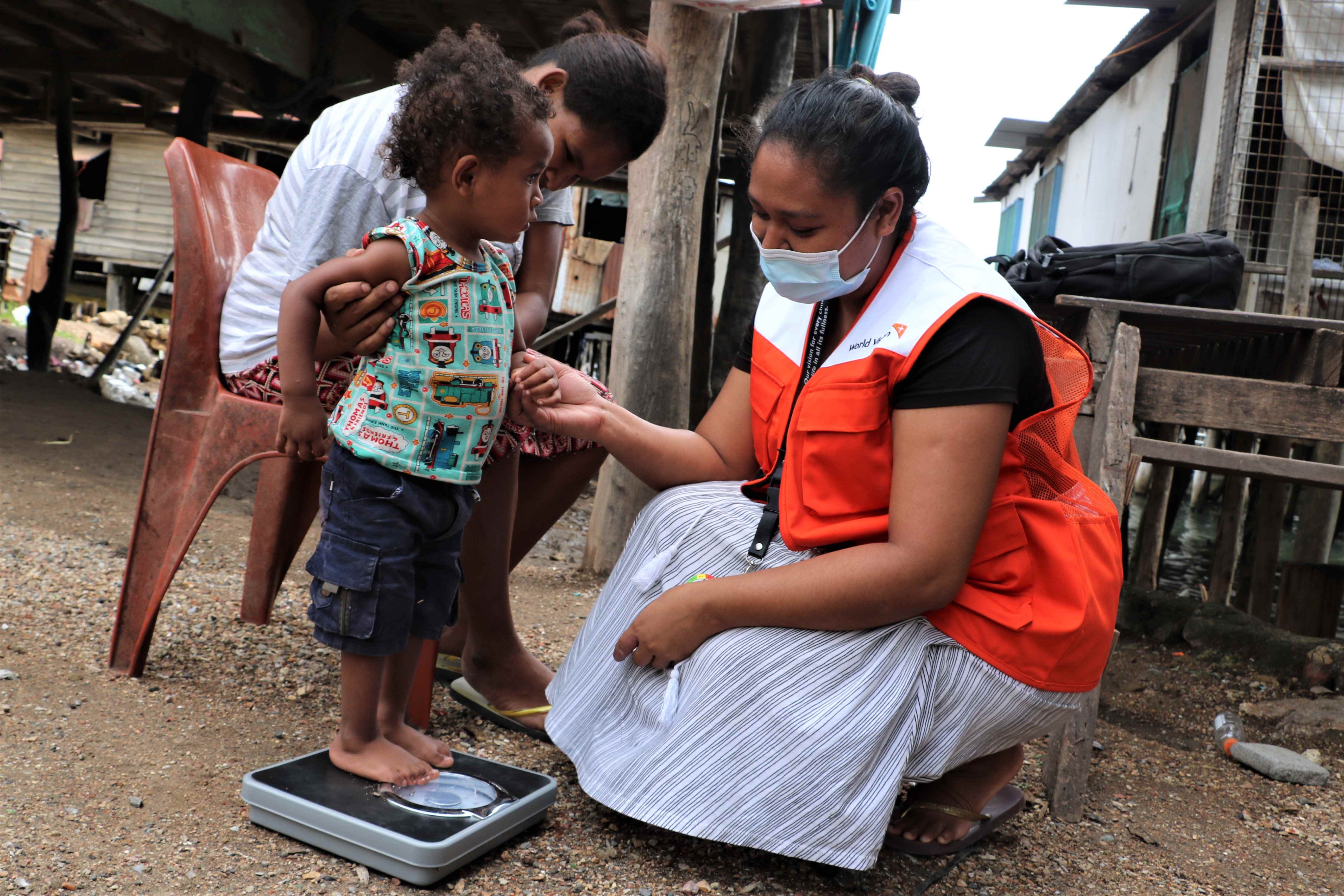 Caring For Nutrition (C4N) project staff - Joanne Atava visits Rex and his mother regularly to weigh and measure him.
