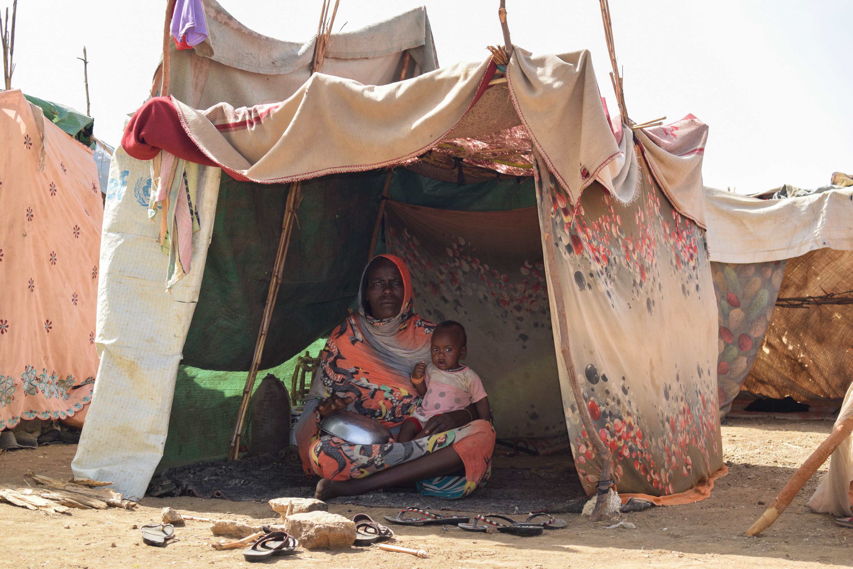 A family forced from their home in Sudan, now living in a make-shift tent
