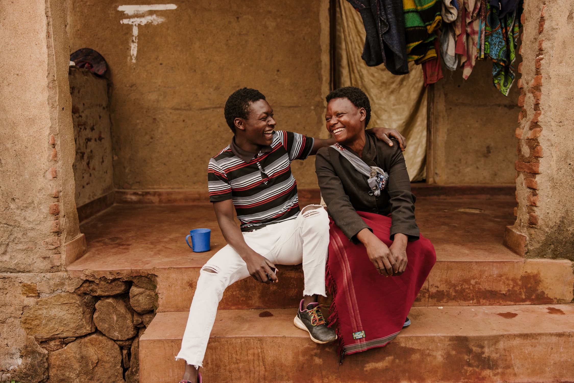 Adult son and mother smiling together in Malawi