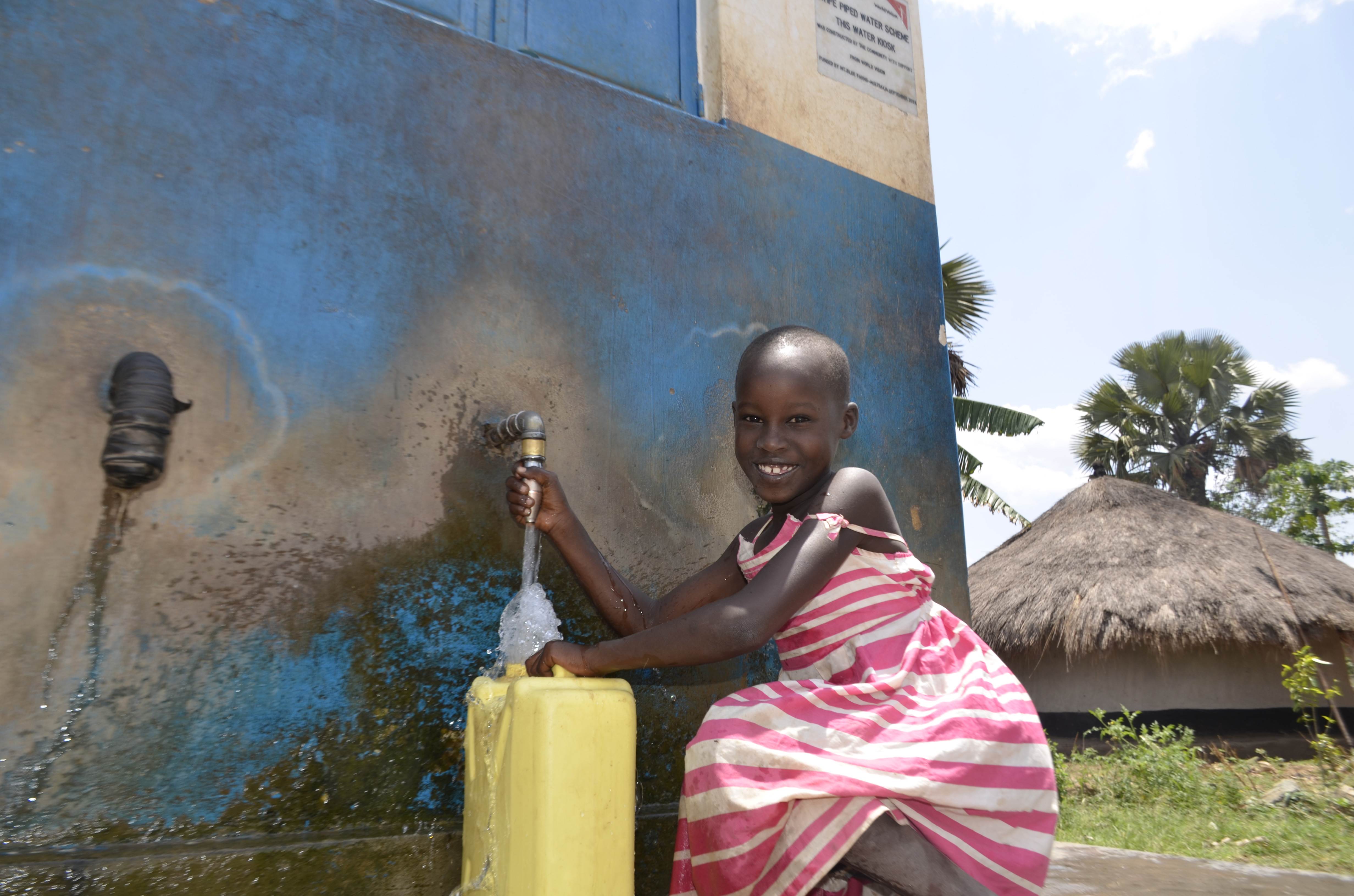 Tracy in Uganda collects clean water near her home now