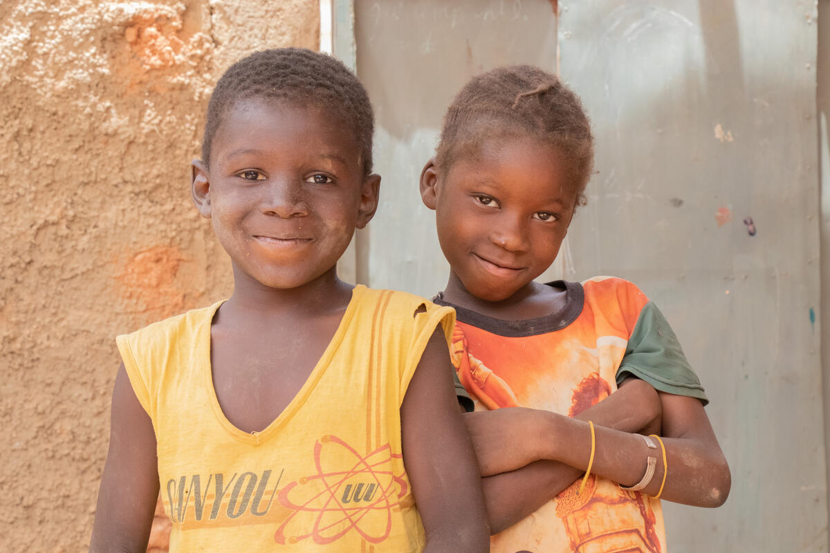 Two boys with a water container