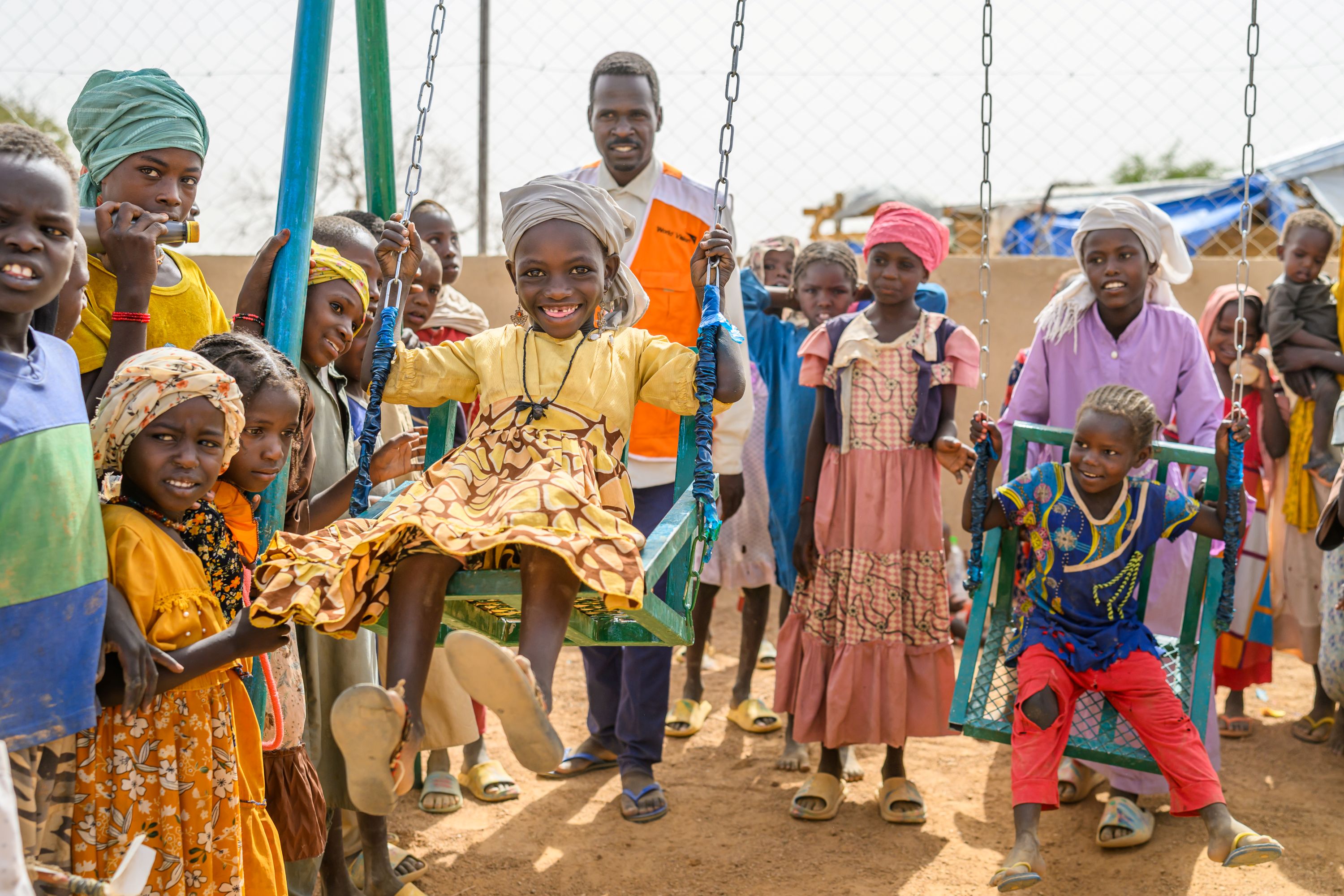 World Vision staff and volunteers play with Sudanese children at a Child Friendly Space