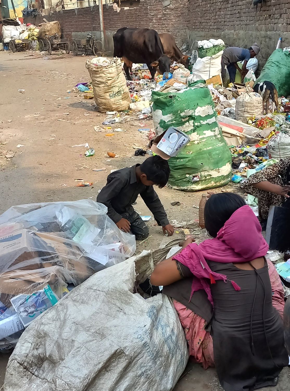 Children searching rubbish for rags to recycle in India
