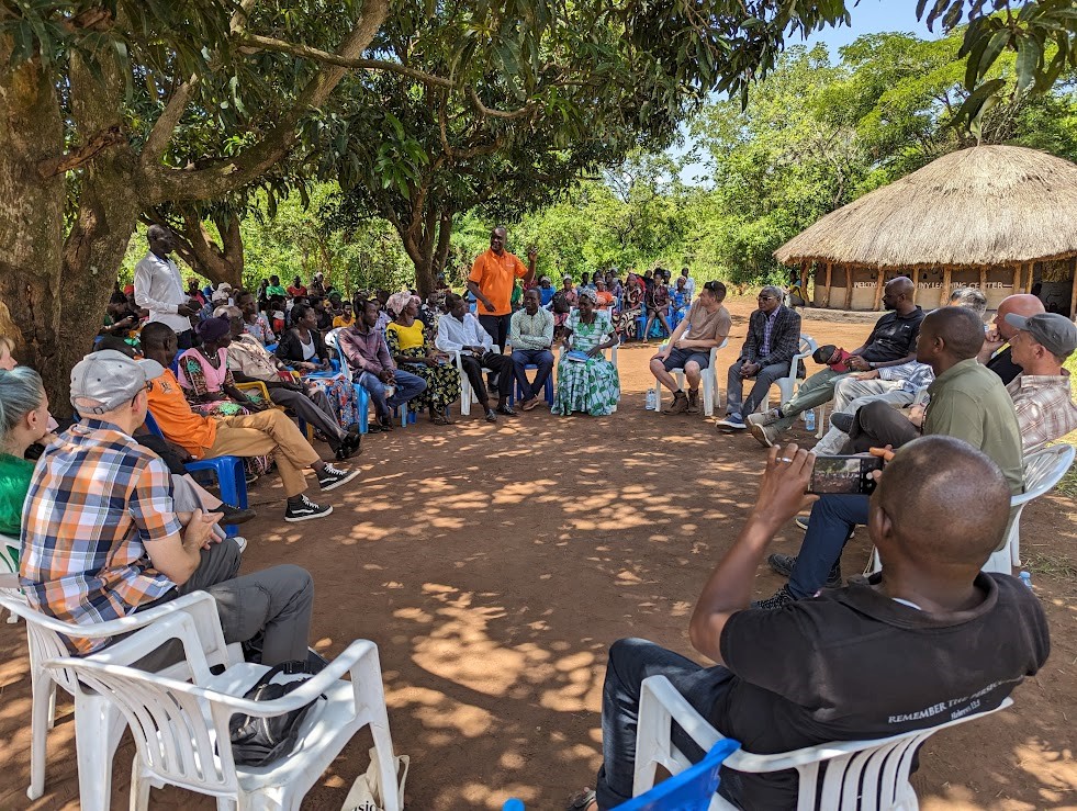 Sitting in a circle for a meeting in Uganda