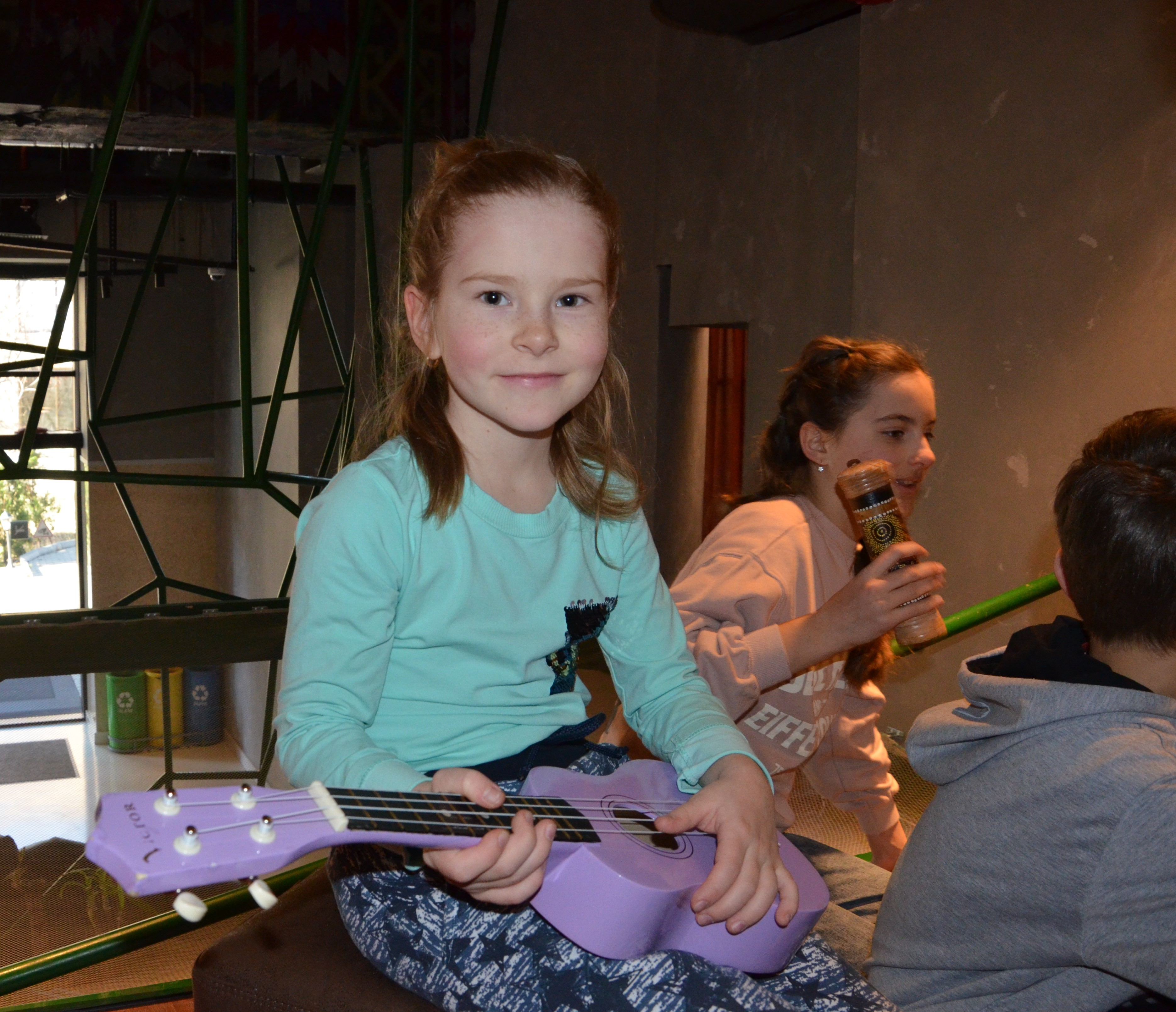 Young girl holding a purple guitar in music therapy in Georgia