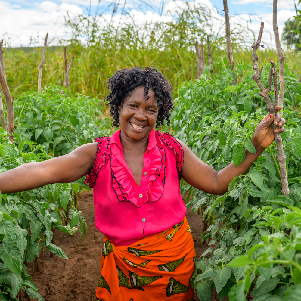 A woman smiling in her garden